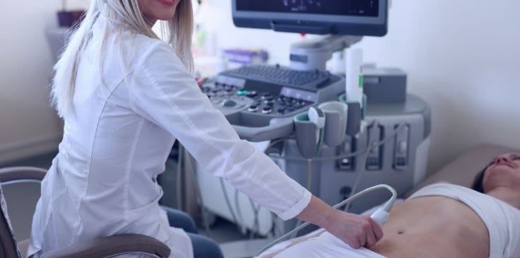 Medical professional conducting an ultrasound-guided liver biopsy.