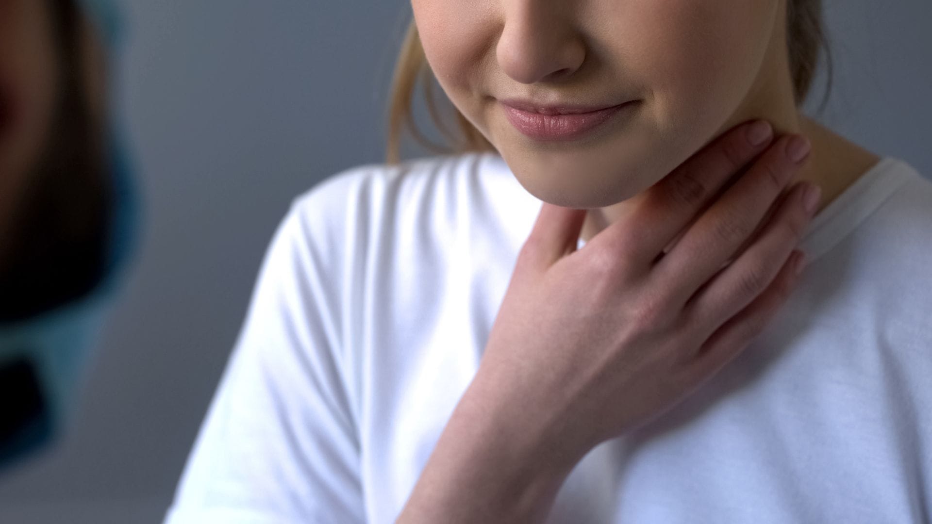 Woman Touching Her Throat